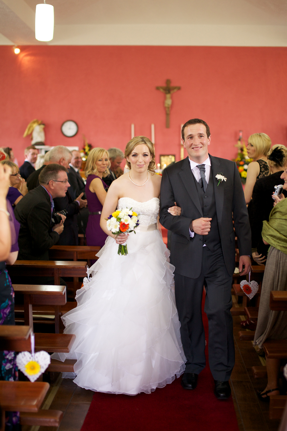 bride and groom walking down wedding aisle